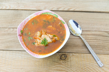 Ukrainian and Russian beetroot soup - borscht with chicken meat on wooden table. Top view