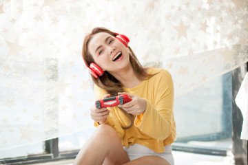 Asian Thail girl smiling and happy for play computer game in livging room