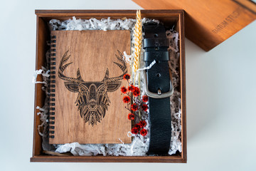 man's gift with a notepad made of wood and a belt