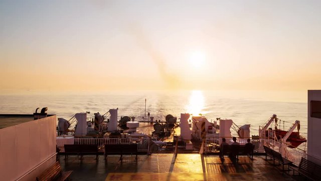Beppu, Japan. Riding a ferry from Osaka to Beppu, Japan at sunrise. Time-lapse with rising sun, horizon over the sea