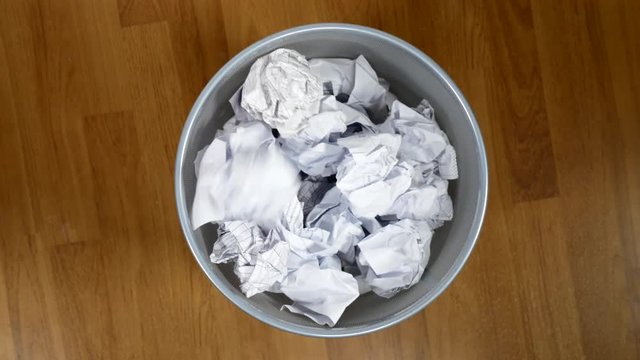 Throwing paper into the waste basket