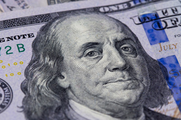 Obraz na płótnie Canvas Closeup of a hundred dollar bill. Background of dollar bills. American Dollars Cash Money. Hundred Bucks. Benjamin Franklin's portrait