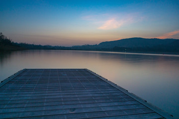 Fototapeta na wymiar Sunset on a lake with pier