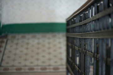 Authentic Soviet style staircase with rusty heavy metal railing in an abandoned building