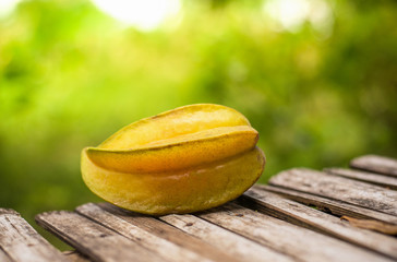 tropical fruit star apple on wood green nature background / Averrhoa carambola