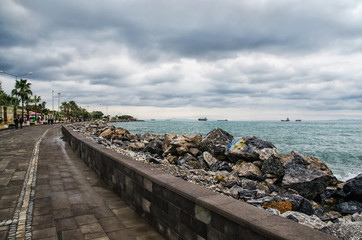 Dramatic landscape on a storm sea in Iskenderun, Turkey with stone pier