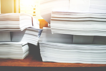 Stack of paper files.Paper documents stacked on wooden desk at workplace.Business Concept.