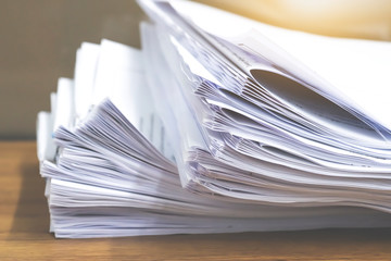 Stack of paper files.Paper documents stacked on wooden desk at workplace.Business Concept.