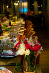 Naklejka na ściany i meble served table in restaurant with flowers