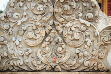 Old white wall design bas-relief with stucco wild flower vine element. Beautiful traditional Thai style stucco wild flower vine patterned for decorative on wall background.