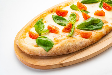 Pizza Margherita on the wooden board. Pizza Margarita with Tomatoes, Basil and Mozzarella Cheese