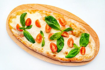 Pizza Margherita on the wooden board. Pizza Margarita with Tomatoes, Basil and Mozzarella Cheese