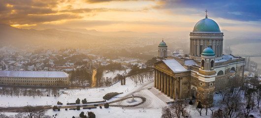Esztergom, Hungary - Aerial panoramic view of the snowy Esztergom Basilica on a foggy winter sunrise