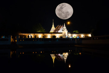 Candle lit tradition, walk with lighted candles in hand around a temple with beautiful moon