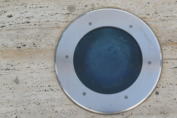 close up of a round lamp in marble surface