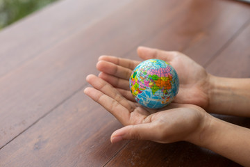 Children hand holding Earth globe model ball,Concept: Protecting the environment to save the world,The dream of sustainability for the new world,symbol responsibility safety  for happy