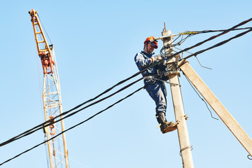 power electrician lineman at work on pole