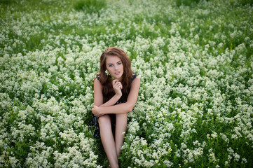 Model posing outdoors in white lavender flowers.