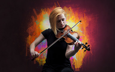 Young classical violinist musician with colorful splotch wallpaper
