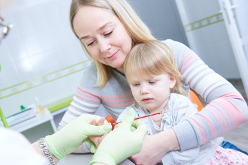 Blood medical test or research. Taking a blood sample from child finger in hospital