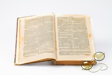 Vintage antique book with old spectacles