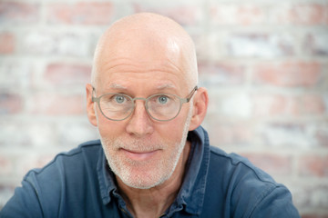 portrait of a senior man with beard and glasses