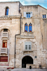 Fototapeta na wymiar ancient facade with windows in historic split, travel croatia
