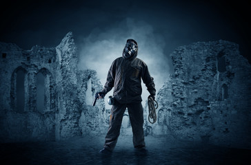 Fototapeta premium Hazard, menace man in a ruined crumbly building with arms on his hand 