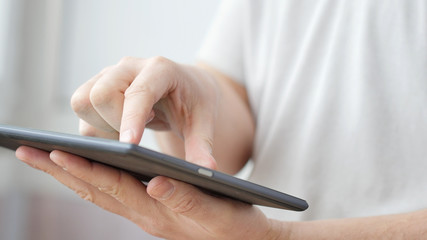 Man hand touching screen on modern digital tablet pc.