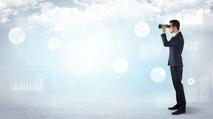 Businessman looking forward with binoculars cloudy background and graphs, charts around
