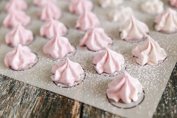 Small white and pink meringues or zephyr