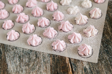 Small white and pink meringues or zephyr