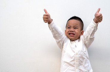 very happy asian boy making thumbs up sign on white background