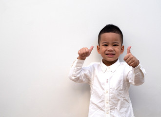 very happy asian boy making thumbs up sign on white background