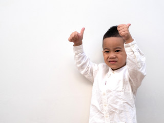 very happy asian boy making thumbs up sign on white background