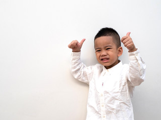 very happy asian boy making thumbs up sign on white background