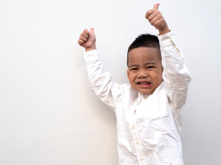 very happy asian boy making thumbs up sign on white background