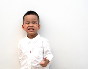 very happy asian boy making thumbs up sign on white background