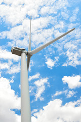 wind generator is on bright cloudy sky background. Power and energy concept.