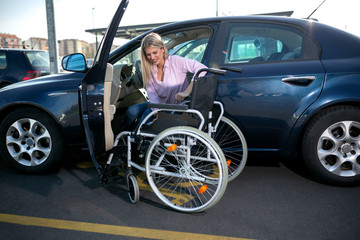 Blonde girl with loss of leg function sitting in the car