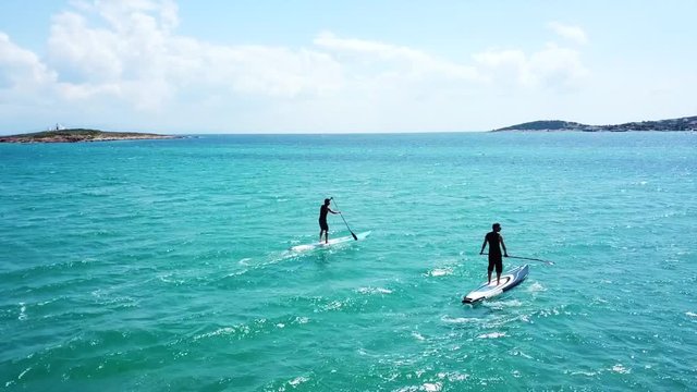 Aerial drone video of competition sport paddle surfing or sup in tropical Caribbean sea