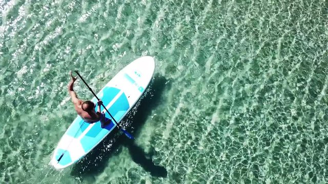 Aerial drone video of competition sport paddle surfing or sup in tropical Caribbean sea