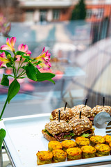 mini tarts with champignons and mini burgers with fried mackerel, tartar sauce, fresh cucumber and ice salad at catering event on some festive event, party or wedding reception