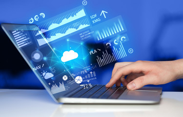 Hand using laptop with cloud technology and linked information concept