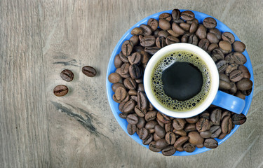 coffee in a blue cup on a wooden table. top view. copy spaces