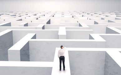 Small businessman in a middle of a huge maze
