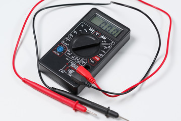 Tool for checking electrical circuits. Digital multimeter on white background