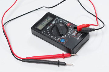 Tool for checking electrical circuits. Digital multimeter on white background