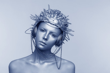 Futuristic woman in metal helmet with screws, nuts and chains
