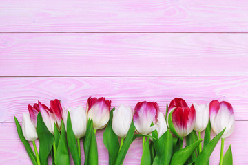 Bouquet of tulip flowers on pink wood background with copy space